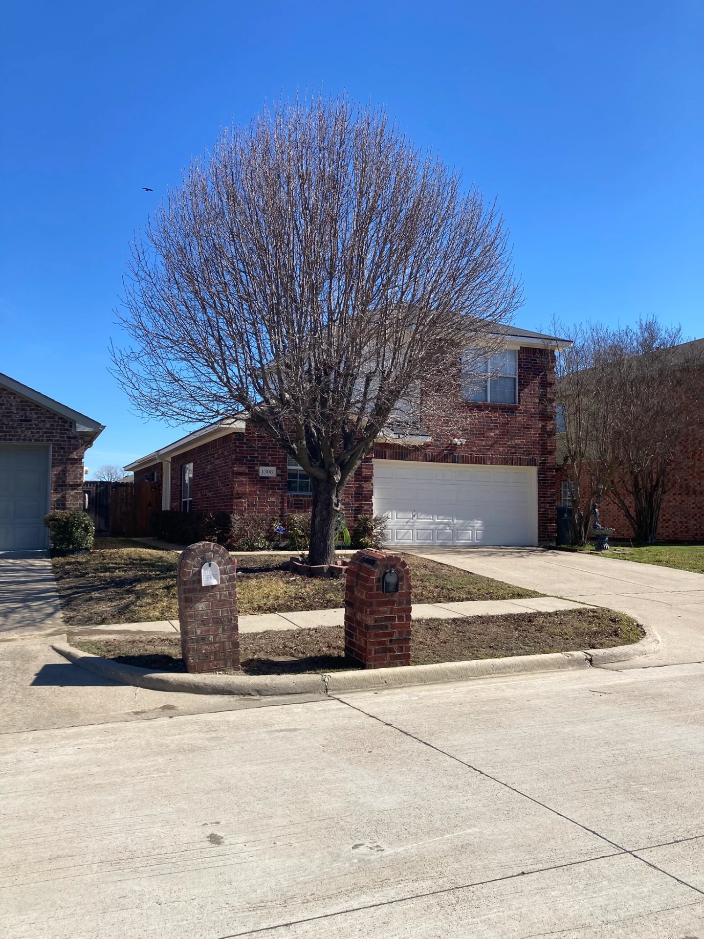 Garland Texas residential neighborhood with brick home and landscaped yard near Lake Ray Hubbard in the DFW metroplex